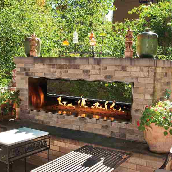 Modern brick patio featuring a sleek double-sided gas design, perfect for cozy outdoor fireplaces gatherings.