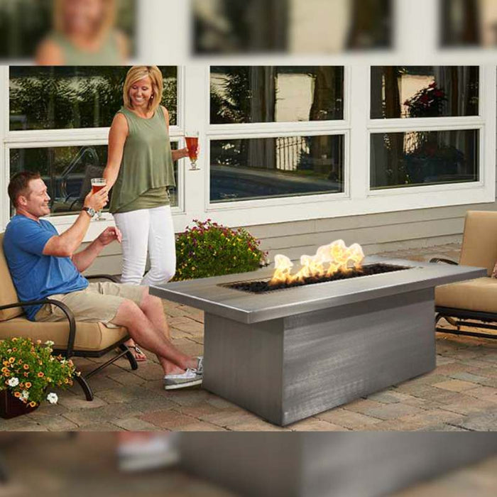 Breckenridge Linear Fire Pit Table - Stainless Steel place at the Lounge with Family plus Lava Rock with Fire Burner On Blur Background