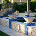 Charleston Fire Bowl - GFRC Concrete 48" Placed in Swimming Pool Area with Cerulean Fire Pebbles V2