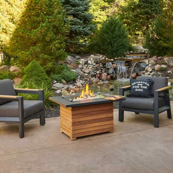 Darien Rectangular Gas Fire Pit Table with Aluminum Top with Clear Tempered Fire Glass Gems On Fire and Glass Wind Guard Wine along near the Water Falls