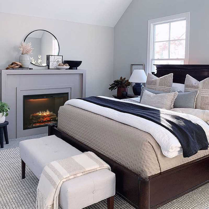 Dimplex Revillusion Traditional Electric Fireplace Placed in Bedroom