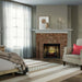 Dimplex Revillusion 30-inch Traditional Electric Fireplace with Herringbone Brick Interior Panel Installed in a Customized Wall in Bedroom Area