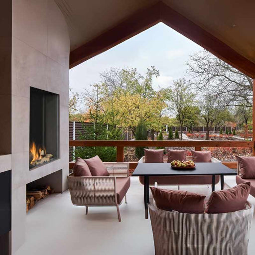 Element4 Sky Medium Outdoor installed at the terrace with Garden view plus Real Flame Burner with True-to-Nature Wood Logs