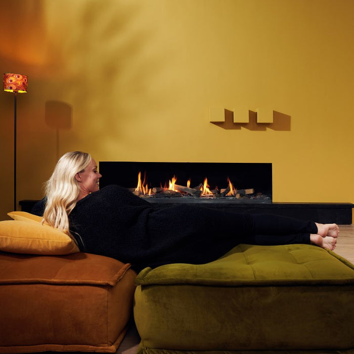 Element4 Summum 190 F with a gorgeous lady relaxing at the Living room with Real Flame Burner with True-to-Nature Wood Logs