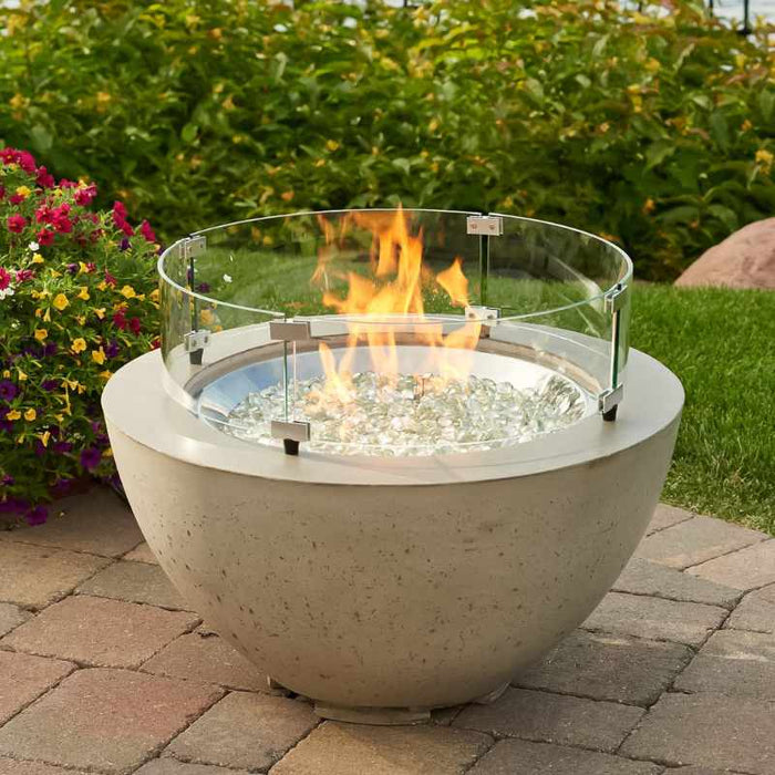 Outdoor Greatroom Natural Grey Cove 29 Round Gas Fire Pit Bowl  Placed at Garden  with Clear Tempered Fire Glass Gems  plus Fire Burner On with Glass Wind Guard Cover