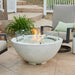 Outdoor Greatroom White Cove 42 Round Gas Fire Pit Bowl Placed at Front Yard with Clear Tempered Fire Glass Gems plus Fire Burner On and Glass Wind Guard Installed