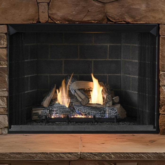 Superior Emberwood Split vent free gas log set burning in a stone fireplace with traditional brick panels