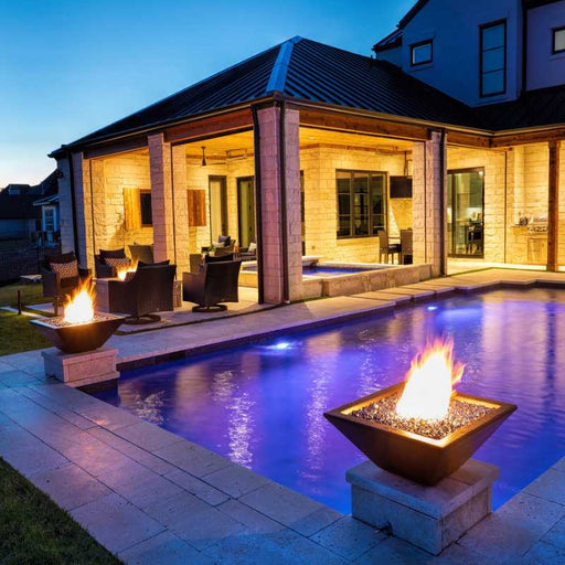 The Malibu Square Fire Bowl in Concrete Placed at the Poolside with Black Reflective Fire Glass plus Bullet Burner On V2