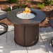 The Outdoor Greatroom Brown Stonefire Round Gas Fire Pit Table Installed at Front Yard  with Clear Tempered Fire Glass Gems plus Fire Burner On Scaled