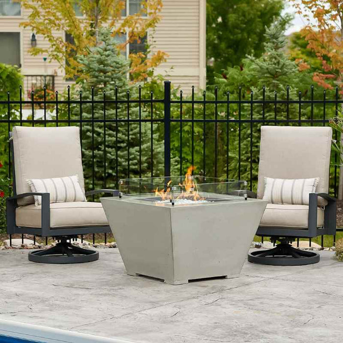 The Outdoor Greatroom Cove Square Gas Fire Pit Bow Place at Courtyard with Clear Tempered Fire Glass Gems plus Fire Burner On with Wind Glass Cover