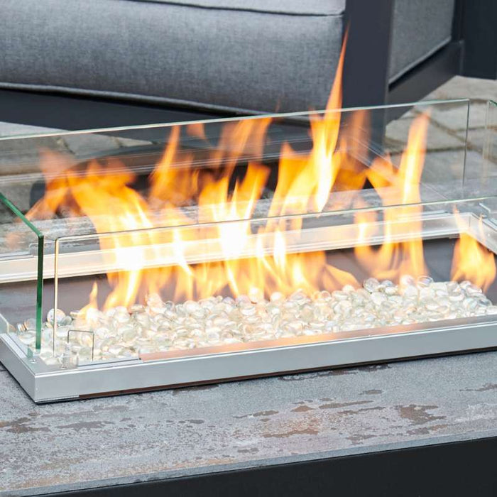 The Outdoor Greatroom Rectangular Folding Glass Wind Guard Up Installed Scaled with Clear Tempered Fire Glass Gems plus Fire Burner On