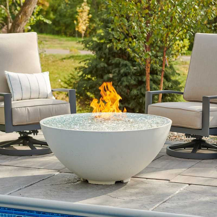 The Outdoor Greatroom White Cove Edge Round Gas Fire Pit Bowl place at Pool Side with Clear Tempered Fire Glass Gems plus Fire Burner On plus Fire Burner On