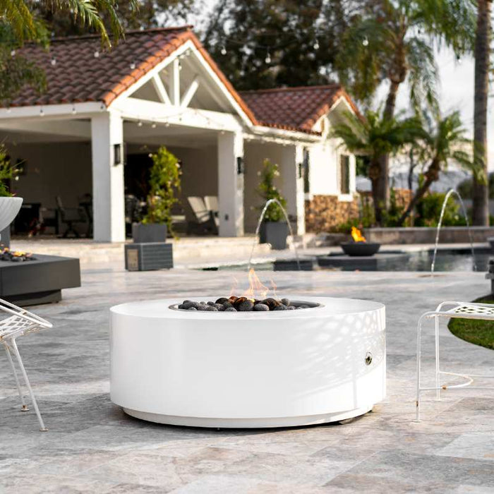 Upland Fire Pit White Powder Coated Metal Installed at the Frontyard with Tumbled Lava Rock plus Bullet Burner On
