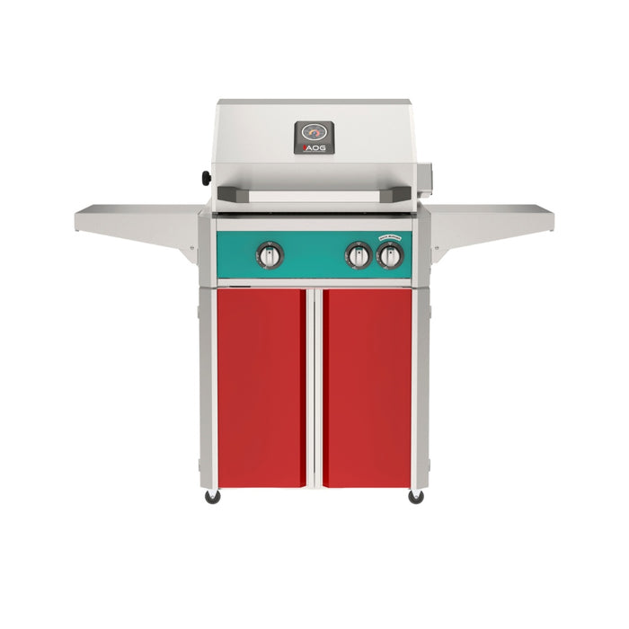 American Outdoor Grill 24" L-Series Portable Gas Grill with teal accent panel and red accent panel cart base, large analog thermometer and push-button electronic ignition with backlit comfort-touch control knobs.