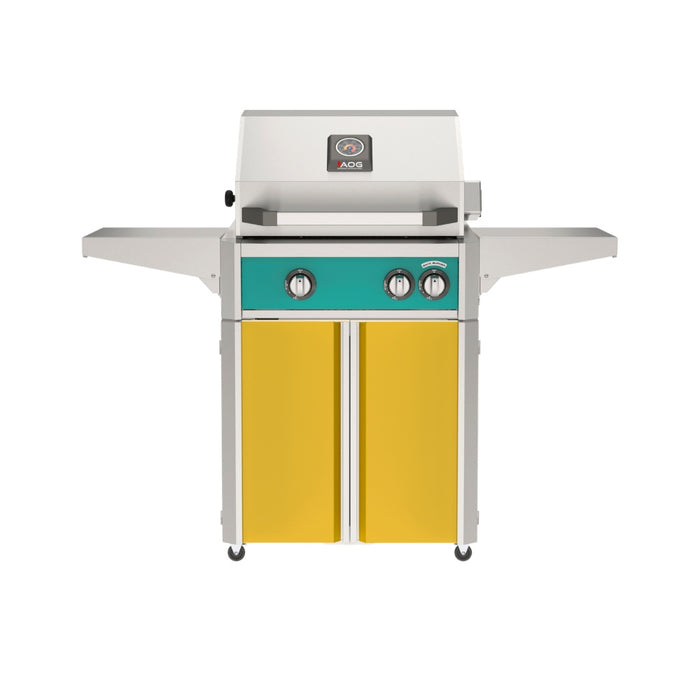 American Outdoor Grill 24" L-Series Portable Gas Grill with teal accent panel and yellow accent panel cart base, large analog thermometer and push-button electronic ignition with backlit comfort-touch control knobs.