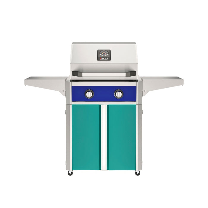 American Outdoor Grill 24" T-Series Portable Gas Grill with blue accent panel and teal accent panel cart base, large analog thermometer and push-button electronic ignition with backlit comfort-touch control knobs.
