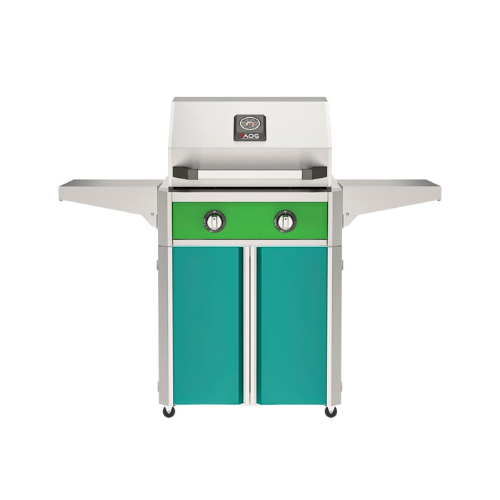 American Outdoor Grill 24" T-Series Portable Gas Grill with green accent panel and teal accent panel cart base, large analog thermometer and push-button electronic ignition with backlit comfort-touch control knobs.
