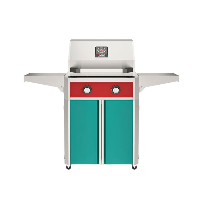 American Outdoor Grill 24" T-Series Portable Gas Grill with red accent panel and teal accent panel cart base, large analog thermometer and push-button electronic ignition with backlit comfort-touch control knobs.
