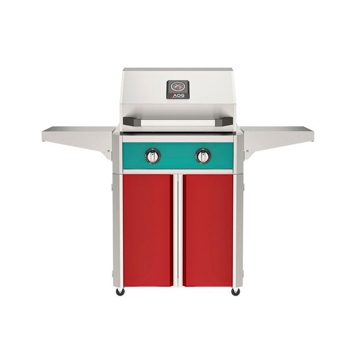 American Outdoor Grill 24" T-Series Portable Gas Grill with teal accent panel and red accent panel cart base, large analog thermometer and push-button electronic ignition with backlit comfort-touch control knobs.
