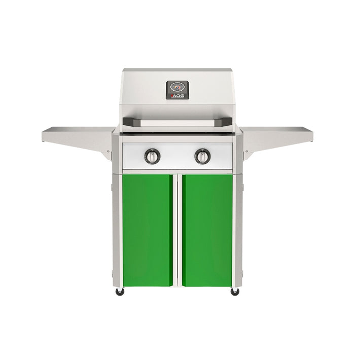 American Outdoor Grill 24" T-Series Portable Gas Grill with white accent panel and green accent panel cart base, large analog thermometer and push-button electronic ignition with backlit comfort-touch control knobs.
