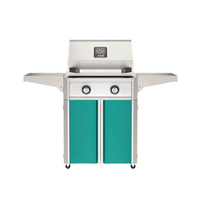 American Outdoor Grill 24" T-Series Portable Gas Grill with white accent panel and teal accent panel cart base, large analog thermometer and push-button electronic ignition with backlit comfort-touch control knobs.

