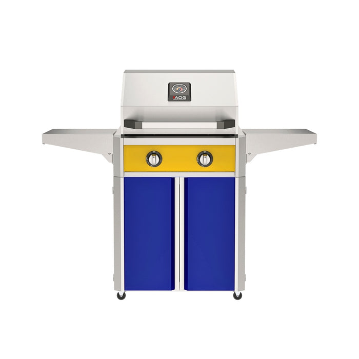 American Outdoor Grill 24" T-Series Portable Gas Grill with yellow accent panel and blue accent panel cart base, large analog thermometer and push-button electronic ignition with backlit comfort-touch control knobs.
