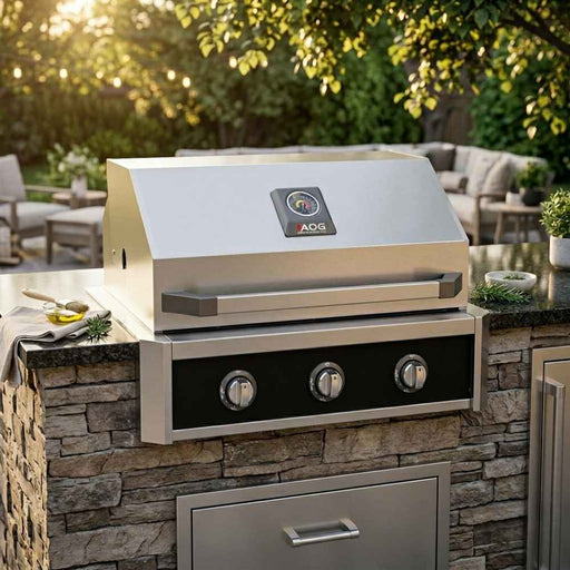 American Outdoor Grill 30" T-Series Built-In Gas Grill (AOG30TN) installed in a stacked stone outdoor kitchen island with a dark granite countertop.