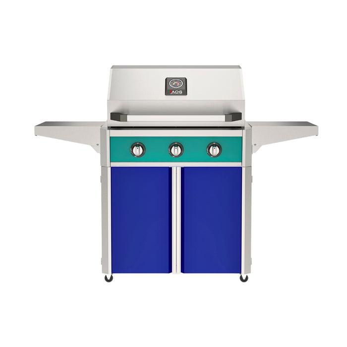 American Outdoor Grill 30" T-Series Portable Gas Grill with teal accent panel and blue accent panel cart base, large analog thermometer and push-button electronic ignition with backlit comfort-touch control knobs.
