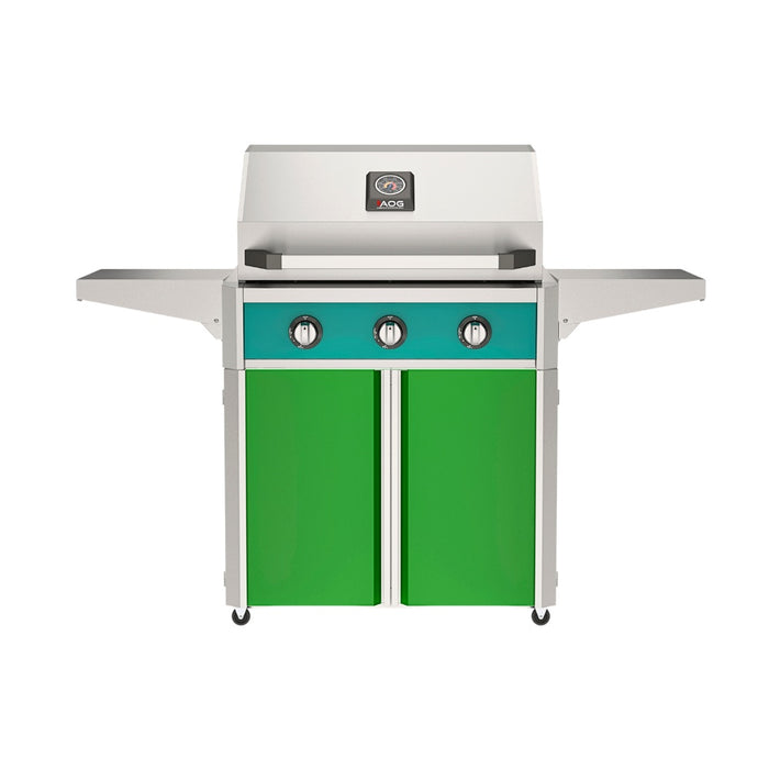 American Outdoor Grill 30" T-Series Portable Gas Grill with teal accent panel and green accent panel cart base, large analog thermometer and push-button electronic ignition with backlit comfort-touch control knobs.
