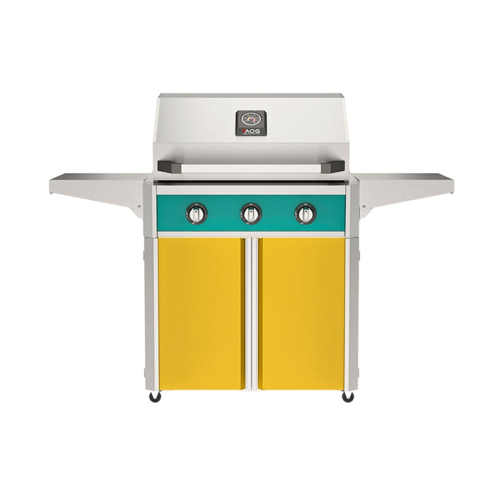 American Outdoor Grill 30" T-Series Portable Gas Grill with teal accent panel and yellow accent panel cart base, large analog thermometer and push-button electronic ignition with backlit comfort-touch control knobs.
