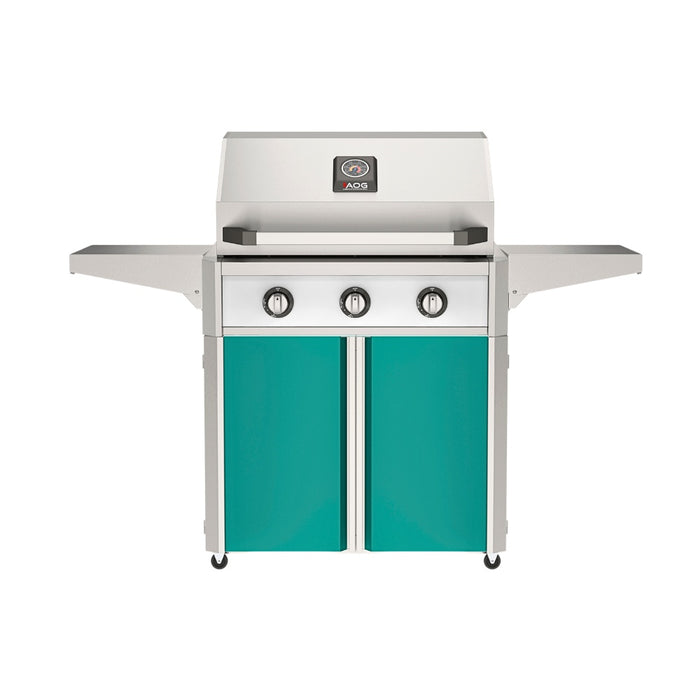 American Outdoor Grill 30" T-Series Portable Gas Grill with white accent panel and teal accent panel cart base, large analog thermometer and push-button electronic ignition with backlit comfort-touch control knobs.
