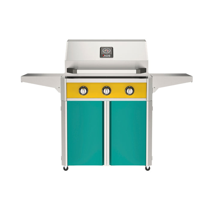 American Outdoor Grill 30" T-Series Portable Gas Grill with yellow accent panel and teal accent panel cart base, large analog thermometer and push-button electronic ignition with backlit comfort-touch control knobs.
