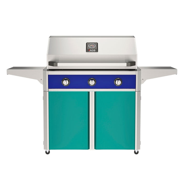 American Outdoor Grill 36" T-Series Portable Gas Grill with blue accent panel and teal accent panel cart base, large analog thermometer and push-button electronic ignition with backlit comfort-touch control knobs.
