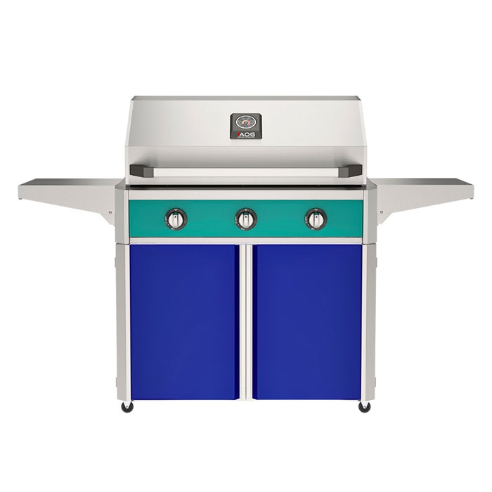American Outdoor Grill 36" T-Series Portable Gas Grill with teal accent panel and blue accent panel cart base, large analog thermometer and push-button electronic ignition with backlit comfort-touch control knobs.
