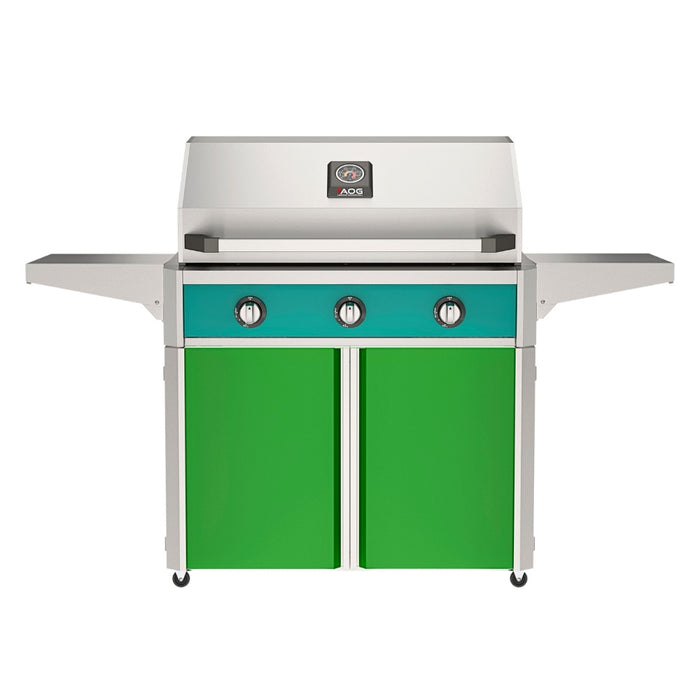 American Outdoor Grill 36" T-Series Portable Gas Grill with teal accent panel and green accent panel cart base, large analog thermometer and push-button electronic ignition with backlit comfort-touch control knobs.
