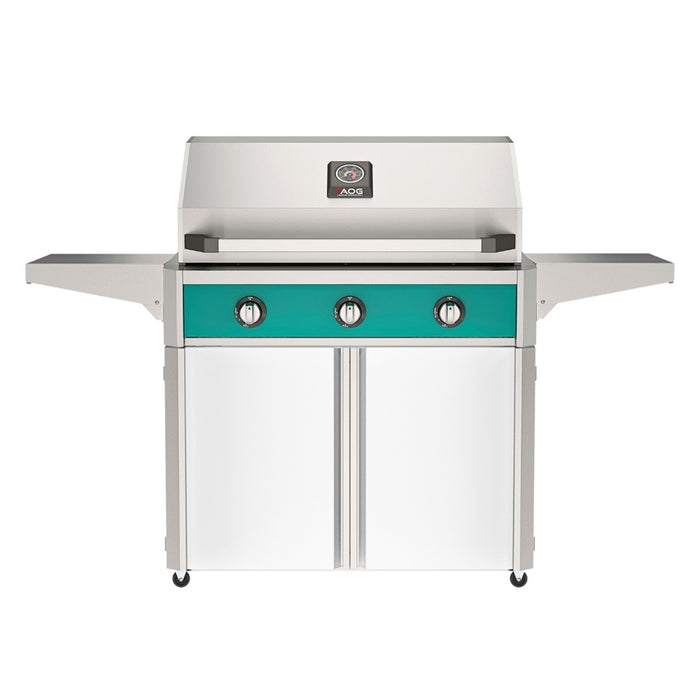 American Outdoor Grill 36" T-Series Portable Gas Grill with teal accent panel and white accent panel cart base, large analog thermometer and push-button electronic ignition with backlit comfort-touch control knobs.
