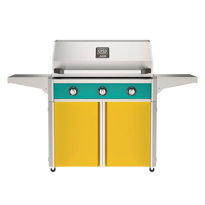 American Outdoor Grill 36" T-Series Portable Gas Grill with teal accent panel and yellow accent panel cart base, large analog thermometer and push-button electronic ignition with backlit comfort-touch control knobs.
