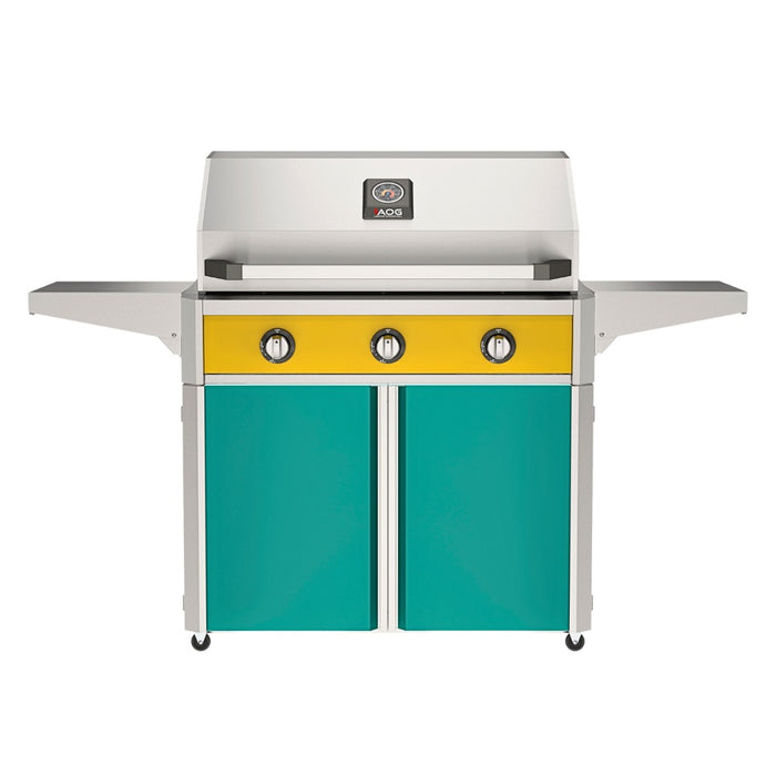 American Outdoor Grill 36" T-Series Portable Gas Grill with yellow accent panel and teal accent panel cart base, large analog thermometer and push-button electronic ignition with backlit comfort-touch control knobs.
