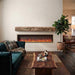 Fireside finishings weathered barnwood non-combustible mantel shelf installed above a linear electric fireplace in a modern living room.