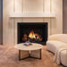 Fireside finishings white modern non-combustible mantel shelf installed above a gas fireplace in a living room.