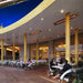 Infratech WD-series electric patio heater integrated into the curved overhead canopy of a modern restaurant outdoor dining patio.