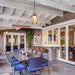 Infratech WD-series electric patio heater installed in a covered patio with an open-rafter ceiling and dining setup.