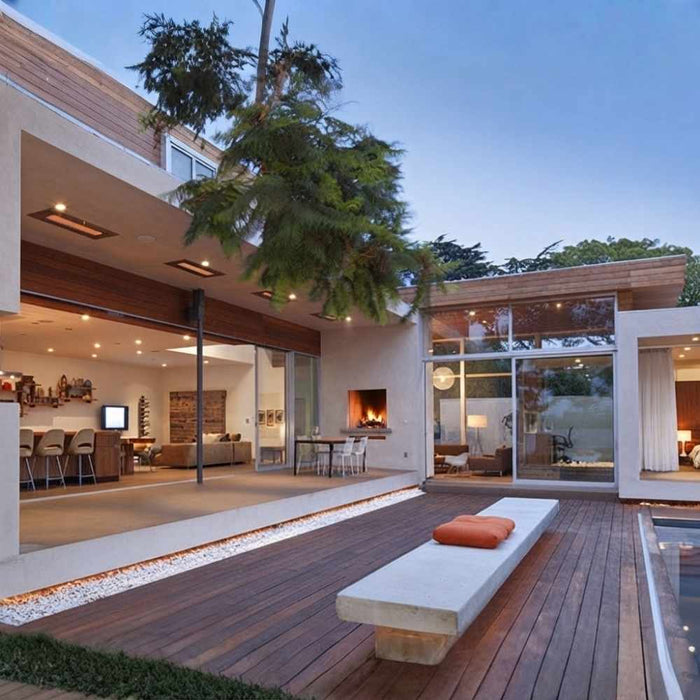 Infratech WD-series electric patio heater    recessed into the modern flat roof overhang of a luxury poolside pavilion.
