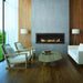 Monessen Artisan vent free linear gas fireplace with stone kit and glass media installed in a modern concrete and wood panel living room."