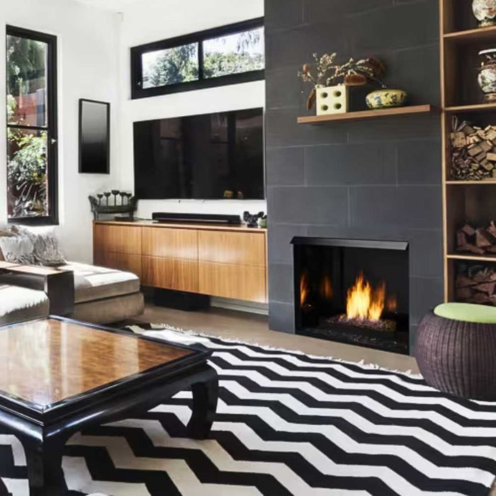 Modern living room featuring a Monessen Lyric contemporary vent-free gas burner with glowing flames embedded in onyx fire glass. 