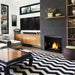 Modern living room featuring a Monessen Lyric contemporary vent-free gas burner with glowing flames embedded in onyx fire glass. 