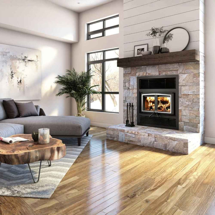 Osburn Everest III high-efficiency wood burning fireplace with brushed nickel door overlay and black traditional faceplate, installed in a contemporary living room with a stacked stone accent wall.