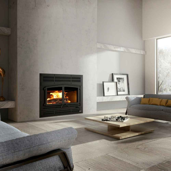 Osburn Horizon high efficiency wood burning fireplace with black Prairie style faceplate and classic moulded brick panels in a modern minimalist living room with grey concrete walls and near in the window view.