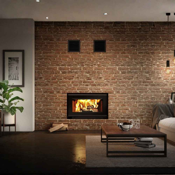 Valcourt Mundo II high efficiency wood burning fireplace with traditional gravity kit installed in a living room