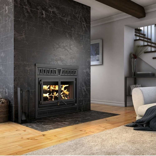 Valcourt Waterloo high efficiency wood burning fireplace with black crown faceplate and molded brick interior panels installed in a modern stone tile accent wall.